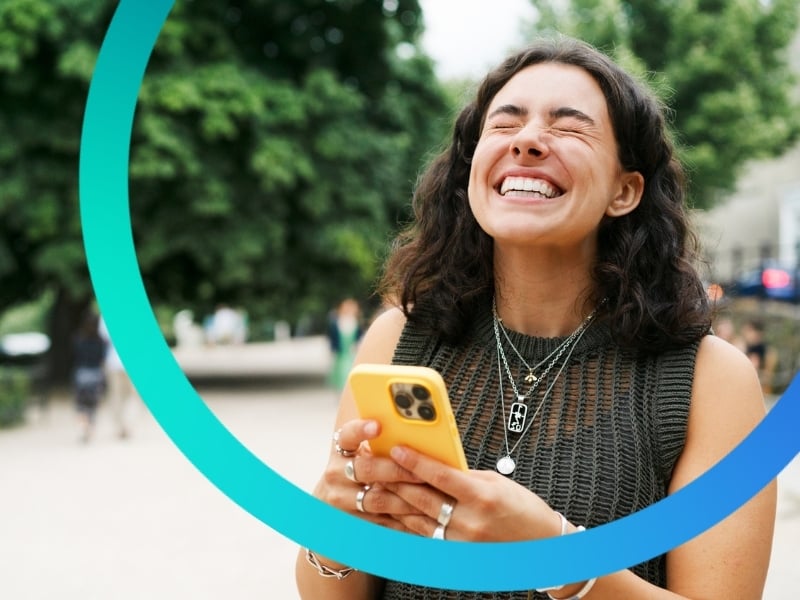 Young woman excited about her new bonus on her phone.
