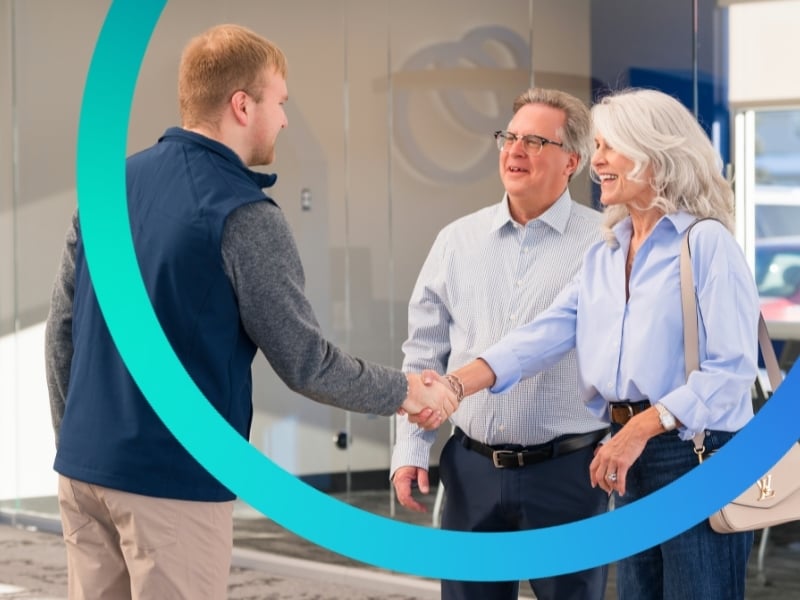 Happy couple being greeted by Magnifi employee in-branch.