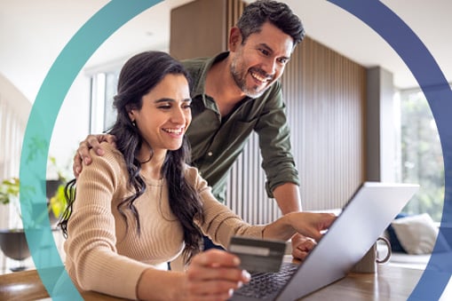 Young couple happy on computer.