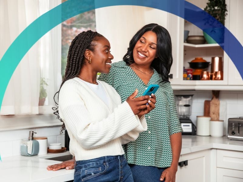 Happy mom and daughter in kitchen using the Greenlight.