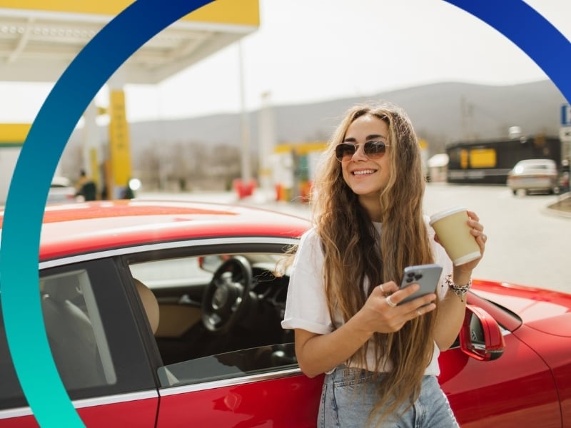 Young woman on a road trip checking her phone.